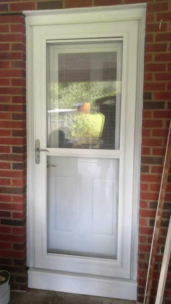 Storm door set into its brick opening