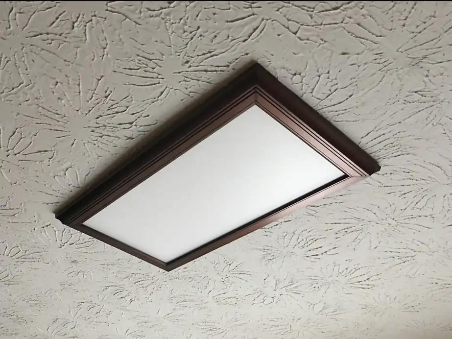 Stained panel set into a textured ceiling where an old 2 by 4 foot fluorescent opening used to be