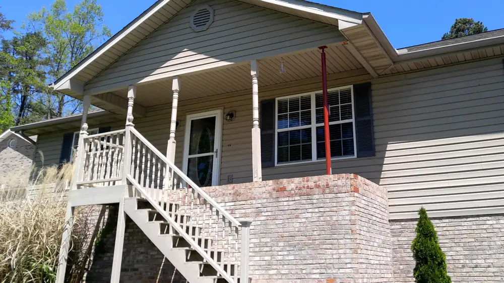 Porch mid-rebuild with new posts standing